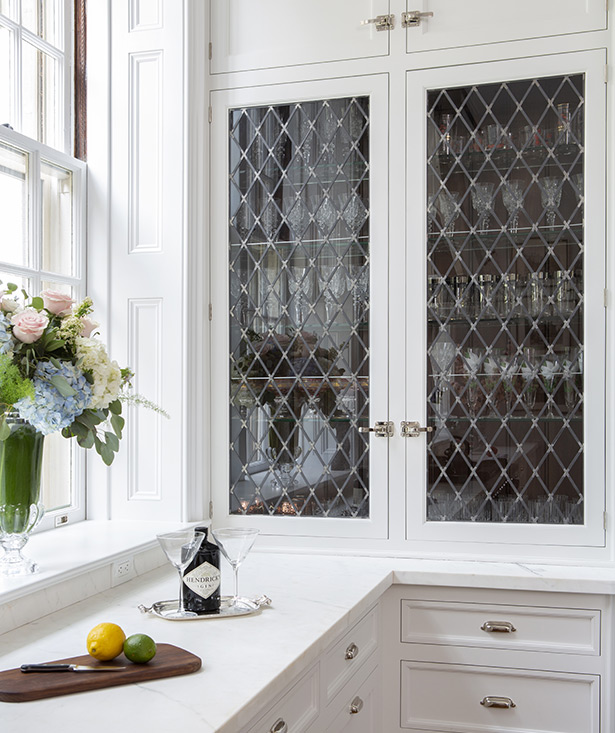 Deep window jambs were designed with panels to replicate the rest of the home’s architectural features. While the original crown molding throughout the home was crafted in plaster, Brahaney explains, “We used wood to mimic the look in the kitchen.”